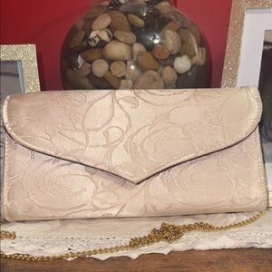 Cream clutch with gold colored chain